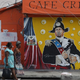 Women walk past a mural in the Little Haiti neighborhood on May 17, 2017 in Miami, Florida.